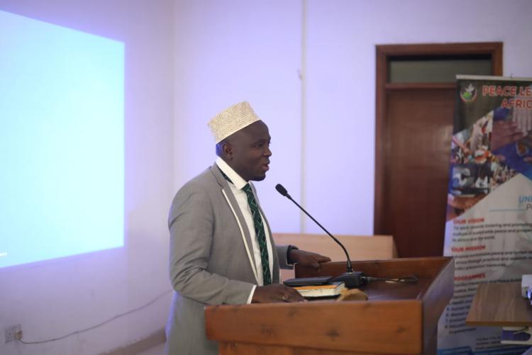 Dr. Hassan Kinyua addressing attendees during the interfaith conference on justice and human dignity.