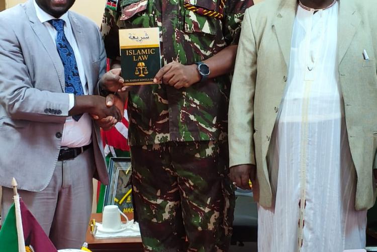 Dr Hassan Kinyua Lecturer at the University of Nairobi philosophy and religious studies hands over islamic law to DIG Gilbert Masengeli